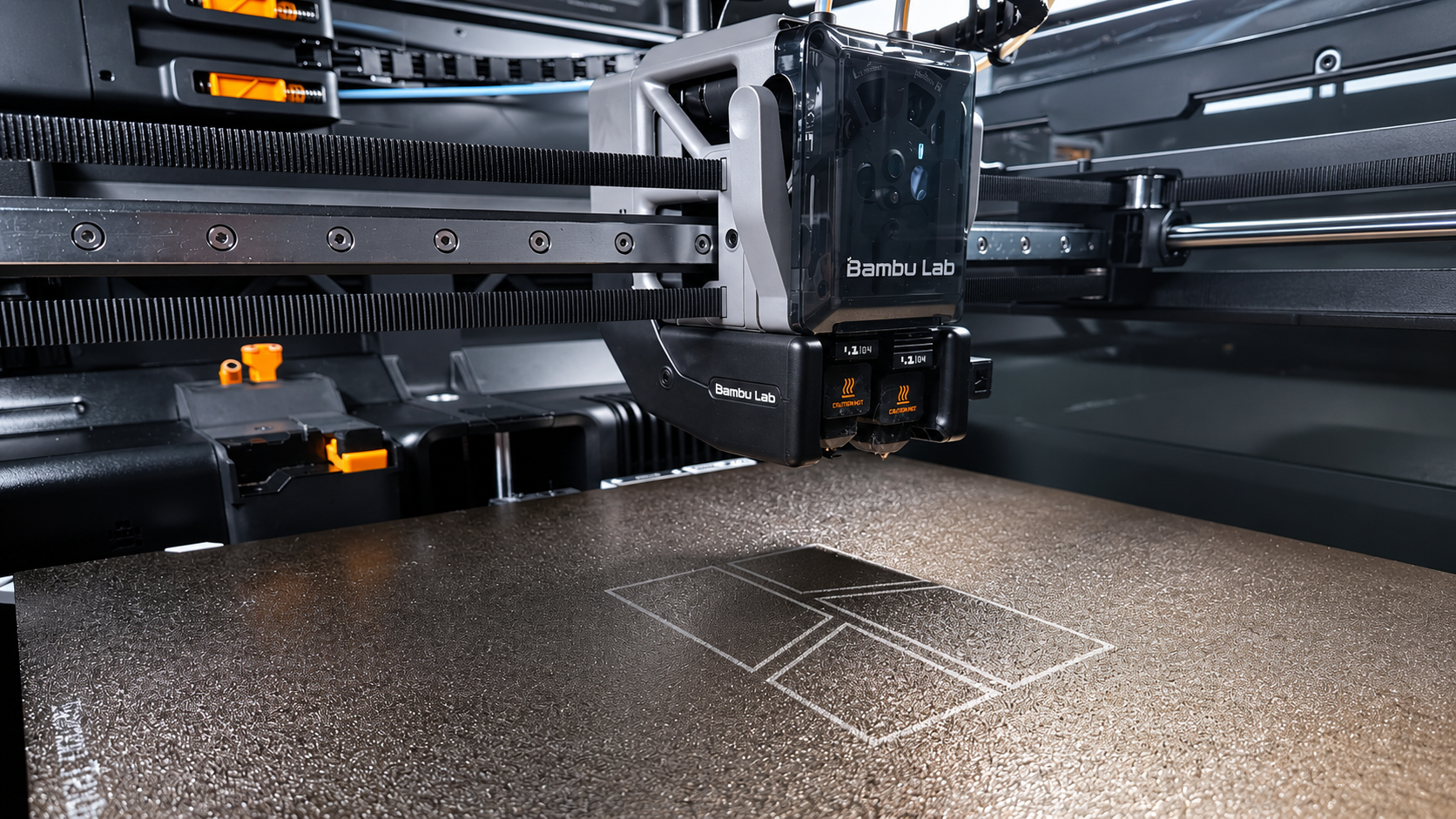 FDM toolhead laying down the first layer on a textured build plate